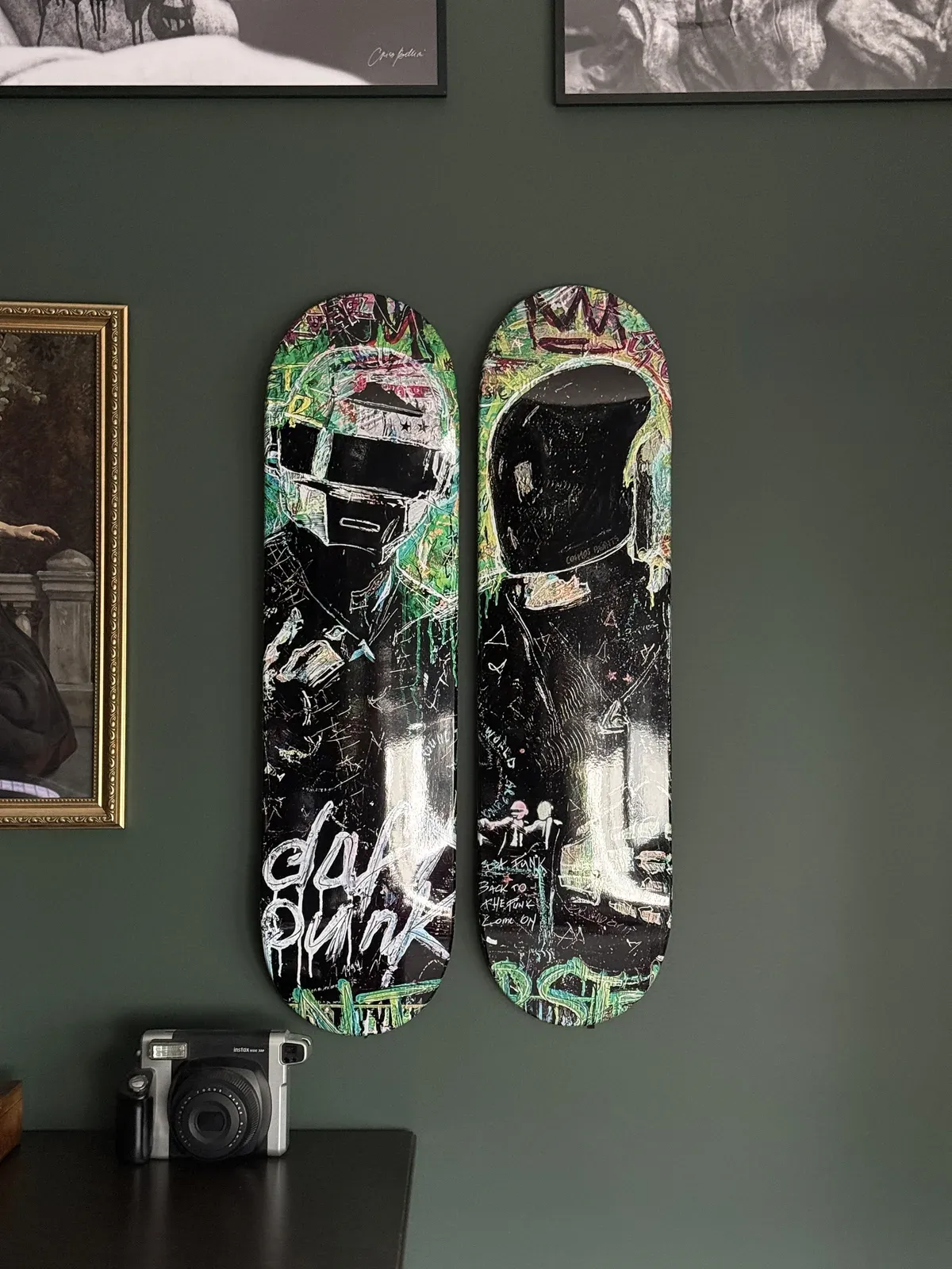Daft Popart’uras deck hanging as wall art against a green wall